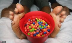 Sugar Soles is shocked to find a dick in her Skittles!! Footjob with huge exploding cumshot!