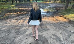 girl was walking along a dirt road in high-heeled mules and lost her shoe and searched for it for a long time