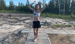 girl bathes in mud, staining her stomach and the rest of her body with mud