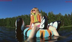 Alla floats on a bright inflatable swan on the lake and wears an inflatable vest for safety!!!