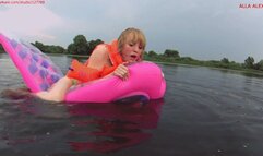 Alla rides hotly on a transparent pink squeaky air mattress on the lakes and wears an inflatable vest and inflatable armbands on her arms and pop the nail of the air mattress during the pleasures!!!