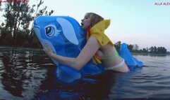 Alla rides on an inflatable squeaky inflatable whale and gets real pleasure, but falls into the water and is saved with the help of an inflatable airline vest!!!