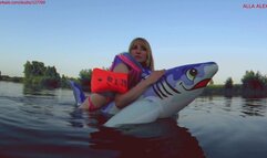 Alla has a hot ride on a rare squeaky inflatable shark on the lake and gets real pleasure!!!