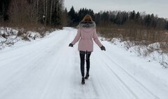 girl walks in high-heeled boots and slips on the ice
