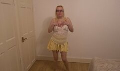 Dancing striptease in yellow miniskirt and pantyhose