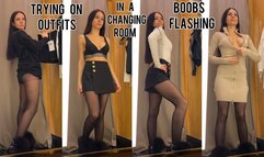 Trying on outfits in a changing room, boobs flashing