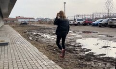 girl in ballet shoes walks through the mud and gets her shoes and feet dirty