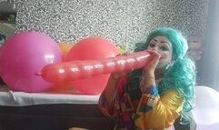 clown girl blow and play with balloons