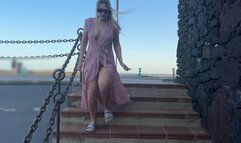 Blonde girl walking along the pier and flashing pussy tits