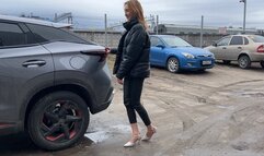 girl in a car plays with her shoes and presses the brake and gas pedals enjoying the sounds of the car