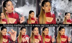Smoking Marlboro Reds close up in a sexy red low cut top