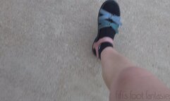 Fifi driving in Teva sandals with black Nike socks