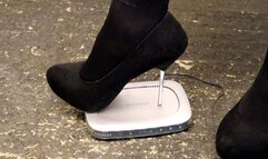 computer router crushed in black metal tipped stilettos