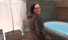 Sexy wife posing in Wellingtons and coat playing with big breasts