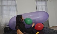 Marianna tries to pop balloons on top of her large GL 1200 balloon