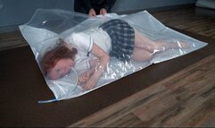 A schoolgirl in a vacuum bag and a hand pump