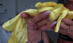 Yellow silk gloves on the neck and around the mouth of a blonde woman aN