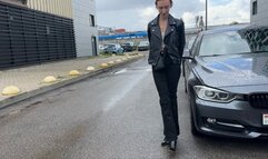 A girl in high-heeled boots walks through deep puddles and checks them for strength, the boots are not very durable and her feet ended up in the water