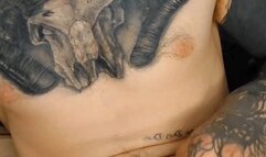 Tatted guy jerking his hard uncut cock and cumming