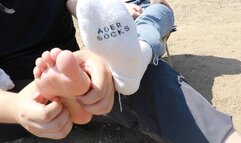 Chinese woman's feet are tickled by the river