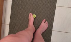 Size 12 feet, long toes picking up a small tennis item, Foot fetish