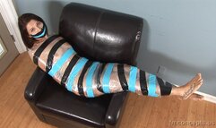 Alternating Coils Of Black And Blue Tape Presses Clear Plastic To The Slender Body Of Ariana Grand!