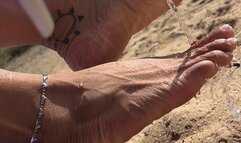 Pretty feet in the sand