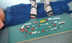 Giantess Jayne vs 30 tiny tiny wiking cars, trucks & bus in chunky sandals toy car crush high left view