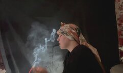 YULIANA LIGHTS HER CIGARETTE WHILE WEARING A HEAD SCARF