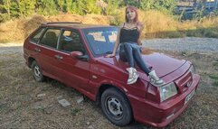 Redheaded babe gives maximum revs on a rusty Lada