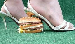 Dom May with high heels squashing the burger