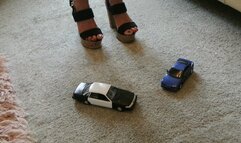 GIANTESS Charn crushes a Ford Crown Victoria police toy car & an old Toyota in chunky high heels close high right view