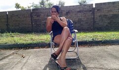 A lady smoking while cross legs and with high heels hanging (3)