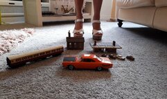 GIANTESS Charn crushes buildings, small cars a train coach and a Plymouth car in chunky white high heels closeup view feet foot toy car crush