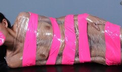 Wrapped In Pink Tape And Plastic, Heather Vahn Is A Tasty Dish Spread Out On The Dining Table