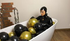 Rubbermissy is enjoying a balloon bath filled with black and gold latex balloons latexsound mask fetish