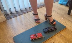 Giantess Lou crushes two old model cars Chevy corvette & Chevy Malibu in big heels high left view