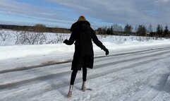 a girl in transparent high-heeled boots walks on ice and constantly slips