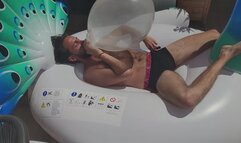 Julien blow balloons and destroy inflatable peacock