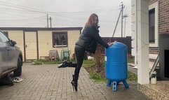 girl in extremely high heels ballet boots walking around the backyard and getting her heels dirty