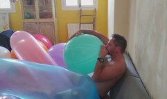 Sebastian blow a big balloon and burst giant ones