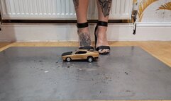 Giantess Atari queen destroys a Plymouth Barracud toy car crush in sexy black heels ground view