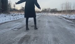 A girl in high-heeled boots decided to walk along the road, but her shoes slipped very much on the ice, so she sometimes even fell