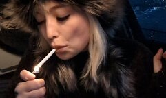 Smoking a cigarette in the car in the evening in winter