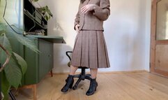 tacher in woolen costume toe tapping in leather boots mov