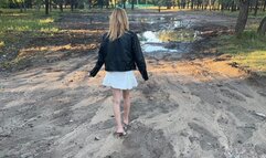 a girl in open-toed shoes walks on very dirty ground, her feet get sucked into the mud, and in one such deep puddle she loses her shoe and goes looking for it (reissue)