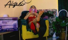 Lady Angela taking selfies in one shoe soles dangling red bottom heels