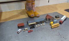 Giantess Atari queen destroys tiny cars buses and buildings toy car crush in sexy yellow wedges close up left view