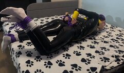 Two bound latex guys play a game of who will fall off the bed first