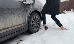 A girl in sexy shoes likes to play with the pedals on someone else's car, she wants to hear a new sound and therefore took someone else's car to press the pedals with her heels and enjoy